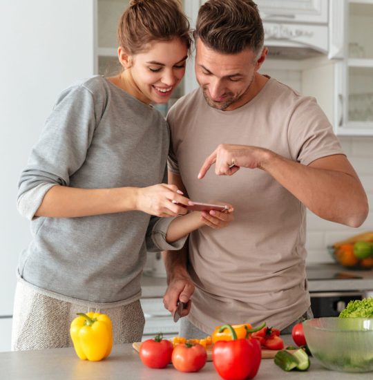 portrait-smiling-loving-couple-cooking-salad-together